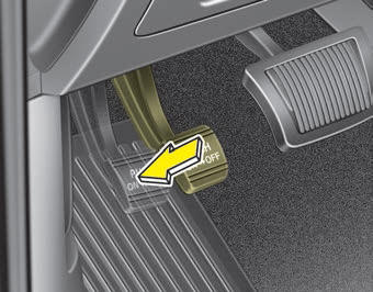 Kia Carnival: Parking brake  Foot type. To release the parking brake, depress the parking brake pedal a second time while