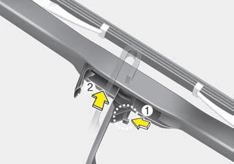 Kia Carnival: Blade replacement. 2. Turn the wiper blade clip. Then lift up the blade clip.